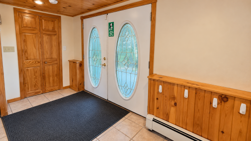 Large front entry featuring attached cedar closet