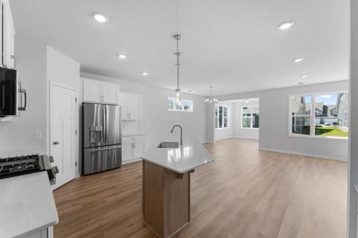 The open and inviting layout includes generous use of windows filling the home with loads of natural light. The luxury vinyl plank floors provide a seamless transition for a spacious feel.