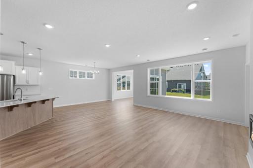 The open and inviting layout includes generous use of windows filling the home with loads of natural light. The luxury vinyl plank floors provide a seamless transition for a spacious feel.