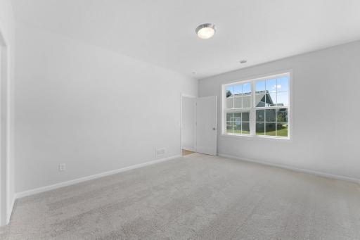 Spacious primary suite is located on the back side of the home for added privacy.