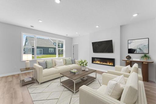 The light filled family room provides enough space for many furniture arrangements. The modern electric fireplace provides the perfect focal point and has a tech tube and outlet to seamlessly mount your TV.