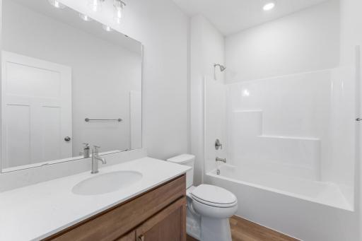 The hall bath is located conveniently between the secondary bedrooms.