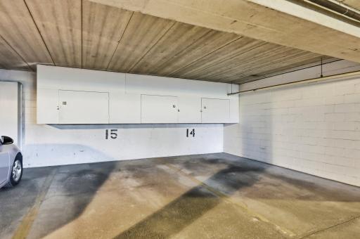 The assigned parking is stall 15, and it comes with its own built-in storage locker above the unit. The stairway to the 2nd floor is next to unit 14, very convenient if you want to get your steps in. The elevator is fairly close as well.