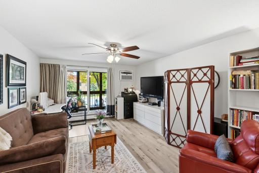 Take a right off the elevator and another right down the hallway to unit 210. Once inside you see the living room and sliding doors to the screened-in porch. Laminated wood flooring throughput the unit and neutral paint to brighten everything up!