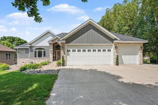 Photo for 301 9th Street SE, New Prague, MN 56071 - listing #7134653 Custom-built home in New Prague on a private drive with metal siding, concrete driveway, and mature landscaping.