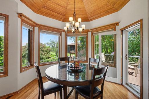 Dining nook with a wood-accent ceiling and direct access to the deck.