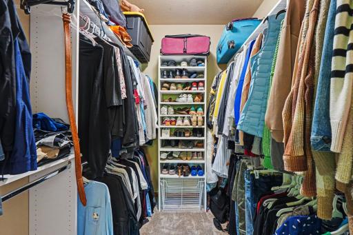 Large walk-in closet off the primary suite with custom built-in shelving and organization.