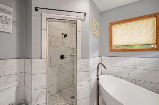 Ceramic tile shower in the primary bath, updated in 2023.