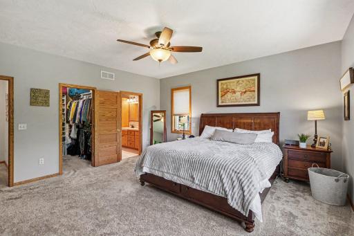 Primary bedroom with motion-activated lighting and a walk-in closet off the en suite bath.