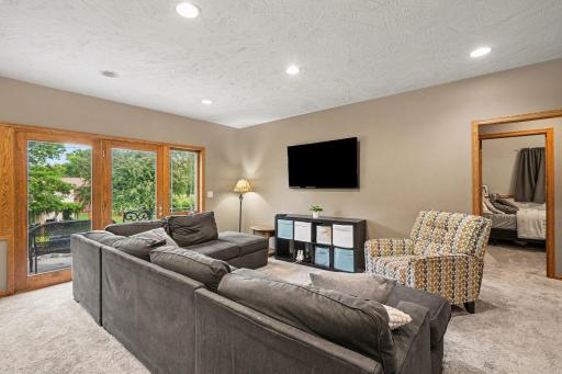 Open lower level family area connected to the wet bar and theater room.