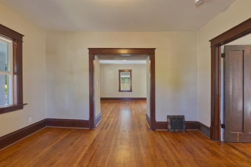 Dining room looking into living room. Front door to the porch to the right