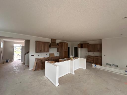 Starting to look like the beautiful home it will be! Gorgeous gourmet kitchen with warm inviting wood cabinets with a wood hood!