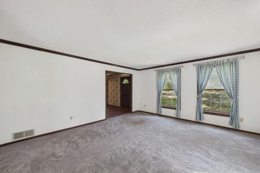 Formal living room with access to front entry