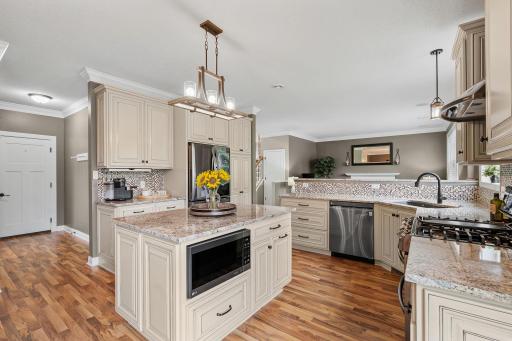 Stunningly remodeled Gourmet Kitchen w/ granite, new cabinetry, SS apps, gas range, Zephyr hood + Kinetico water filtration system