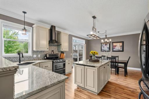 Stunningly remodeled Gourmet Kitchen w/ granite, new cabinetry, SS apps, gas range, Zephyr hood + Kinetico water filtration system