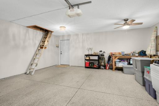 Incredible finished garage with epoxy floors and attic storage.