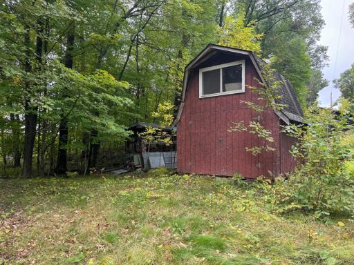 There is a wood shed behind the storage shed