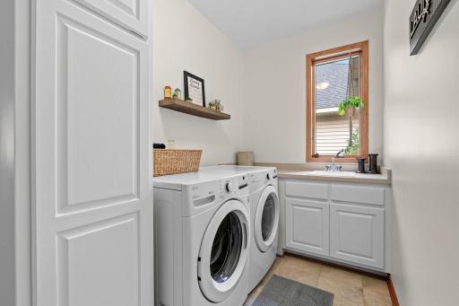Delightful laundry room with storage on convenient main floor