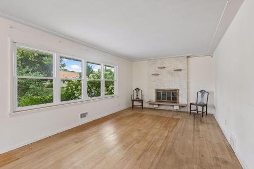True to the 1950's Mid Century homes this one has hardwood floors throughout the main floor. Imagine the floors refinished and this huge living room freshly painted!