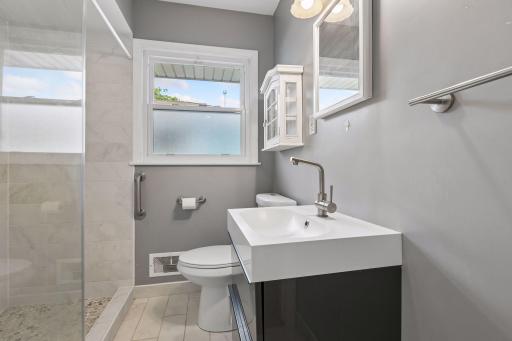 Love this bath featuring a big walk-in shower and gorgeous ceramic tile.