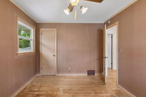 Middle sized bedroom looks out to the backyard.