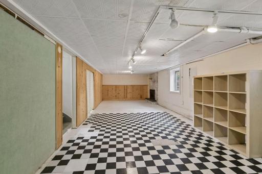 Huge basement partially finished room. Previous owner had a quilting and sewing area on the checkered floor and the far end was carpeted and a sitting area by the fireplace.