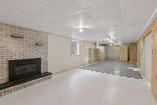 View from the opposite end of the basement. Notice the egress window for potential fourth bedroom. Cabinets and cubbies on the far end stored previous owner's fabric and craft supplies. Thought they could be useful to the buyer.