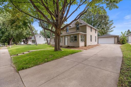 View of large concrete driveway leading to oversized 3+ car garage (2 wide/2 deep)