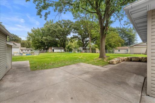View just off the back entry and side of garage showing LARGE yard which was recently brought down to bare dirt and fully re-landscaped including tree removal/triming, seeded, mulch, and new limestone cube retaining wall.