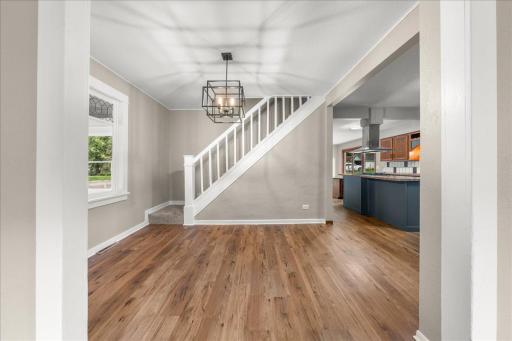 Dining room with view of staircase leading to upper level of the home.