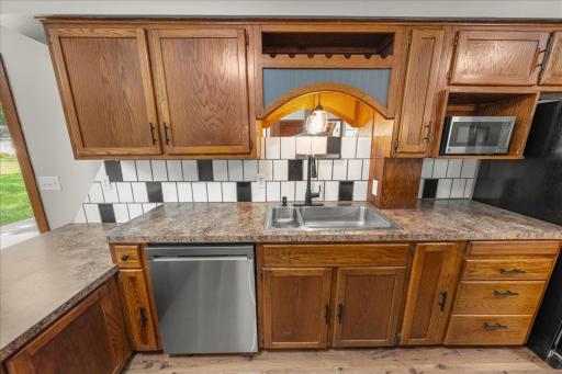 Additional view of the kitchen showing new dishwaher, microwave, faucet, lighting and hardware!