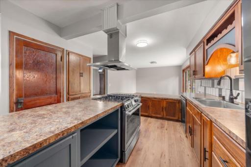 Additional view of the kitchen showing new range & hood in large kitchen island.