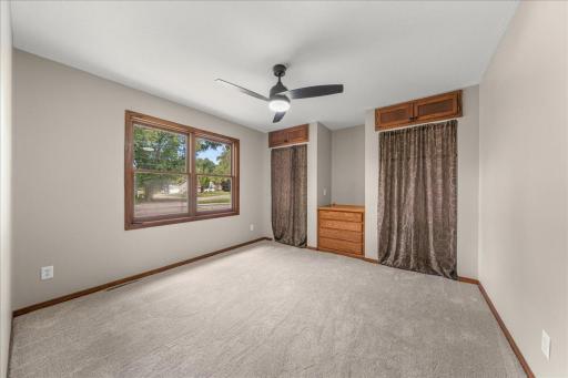 Main floor Bedroom with two closet spaces, brand new carpet, fresh paint, and new ceiling fan!