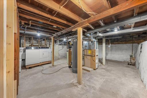 View of lower level with laundry located on back wall.
