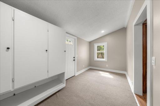 HUGE mud room located off the back entry with built in cabinetery for coats and shoes; new lighting, paint, trim carpeting, & hardware as well.