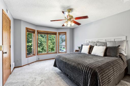 Primary suite has enough space for two chairs near window