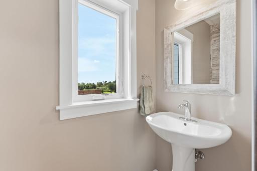 Right off the garage, you'll find the 1/2 bath on the main level.