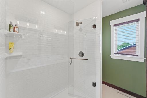 Luxurious walk-in tiled shower in the primary bath.