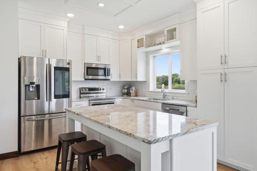 Granite center island with seating for all to gather.