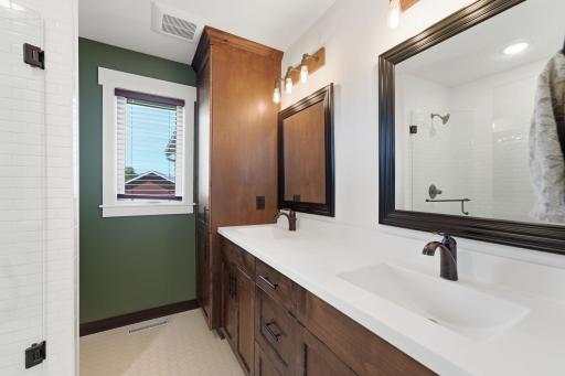 Double vanity with ample storage for 2 in the primary suite bath.