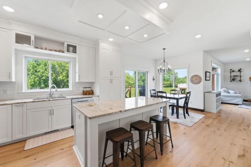 Elevated kitchen & dining with engineered hardwood floors.