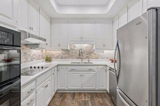 Beautiful white cabinetry with electric cooktop range.