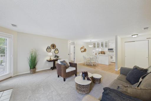 The living room is open to the dining and kitchen area.
