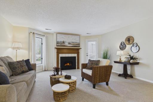 Large living room with an electric fireplace and deck access.