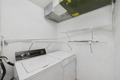 In Unit Laundry Room 5x5 with shelves for extra storage. The washer is a Speed Queen.