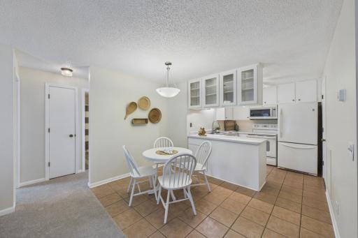 Drop-down cabinets have clear glass cabinet doors on the dining room side.