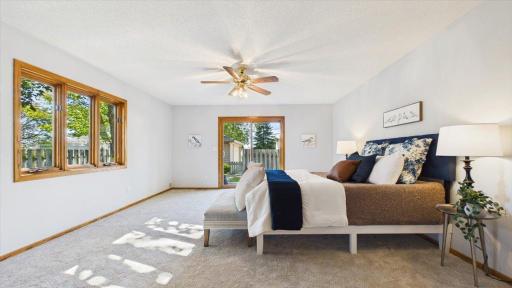 sliding glass doors off the primary bedroom lead to nice deck