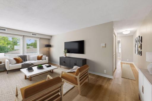 Bright living space with new hardwood flooring, virtually staged for inspiration