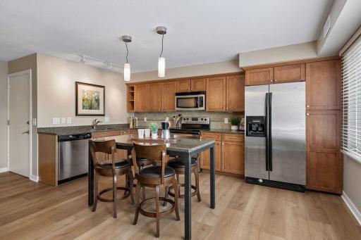 Matching granite center island and table are the perfect addition to the kitchen space, adding both function and style.
