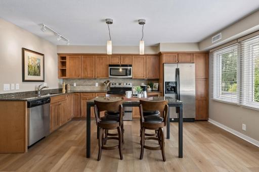 Stunning renovated kitchen with ample wood cabinetry, granite countertops, and stainless appliances